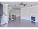 Open-concept living room with a fireplace, hardwood floors, and stairs at 1147 Laurel Valley Ct, Buford, GA 30519