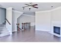 Spacious living room with a fireplace, hardwood floors, and a ceiling fan at 1147 Laurel Valley Ct, Buford, GA 30519