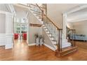 Inviting foyer with hardwood floors, a staircase with iron spindles, and elegant trim work at 2130 Hollowbrooke Nw Way, Acworth, GA 30101