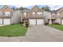 Inviting townhome with a two-car garage, stone accents, and well-maintained landscaping at 8849 Seneca Rd, Palmetto, GA 30268