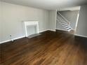 Bright living room with hardwood floors, a fireplace, and a staircase leading to the second floor at 3467 Valley Ridge Sw Ter, Atlanta, GA 30331