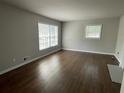 Cozy living room with hardwood floors, two large windows, and neutral paint colors at 3467 Valley Ridge Sw Ter, Atlanta, GA 30331