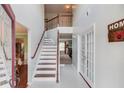 Bright foyer featuring high ceilings, staircase with wood railings, and tile flooring, offering a grand entrance at 3904 Tristan Way, Suwanee, GA 30024