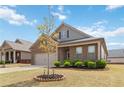 Attractive brick home with manicured landscaping, a two-car garage, and a welcoming front entrance at 558 Carleton Pl, Locust Grove, GA 30248