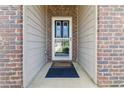Close-up of the home's front door, showcasing brickwork and an inviting entrance with a screen door at 558 Carleton Pl, Locust Grove, GA 30248