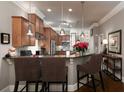Kitchen features granite counters, breakfast bar, pendant lighting, and stainless appliances at 62 Emerson Hill Sq, Marietta, GA 30060
