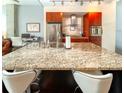 Close up view of kitchen island with granite counters and bar seating at 130 Arizona Ne Ave # 309, Atlanta, GA 30307