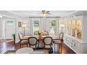 Bright dining room featuring hardwood floors, a large table, and a stylish china cabinet at 1811 Tilliewood Ne Trl, Marietta, GA 30066