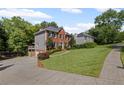 Exterior view showcasing home's brick facade, attached garage and lush, green lawn at 1811 Tilliewood Ne Trl, Marietta, GA 30066