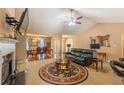 Open living space features a cozy fireplace, dining area, and vaulted ceilings at 5780 Village Loop, Fairburn, GA 30213