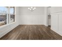 Dining room features wood-look floors, modern lighting, and wainscoting at 7170 Linden Dr, South Fulton, GA 30349