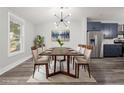 Elegant dining room features modern light fixture, seating for eight, and stainless steel appliances at 358 Roy Sw St, Atlanta, GA 30310