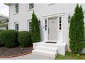 Close up of the front door with sidelights and decorative shrubbery, highlighting the home's welcoming entrance at 3811 Valley Green Dr, Marietta, GA 30068