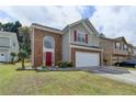 Lovely exterior view of a two-story home with brick and siding, a well-manicured lawn, and mature trees at 2274 Stancrest Ln, Lawrenceville, GA 30044