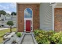 Close up of the front exterior showing an arched window above the red front door at 2274 Stancrest Ln, Lawrenceville, GA 30044