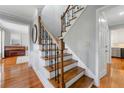 Elegant staircase with wood treads and wrought iron spindles leading to the upper level at 292 Old Rosser Rd, Stone Mountain, GA 30087