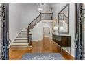 Grand foyer featuring a curved staircase with iron railings and hardwood floors at 5780 Heards Forest Dr, Atlanta, GA 30328