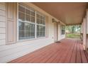 Inviting front porch showcasing a red wood floor, exterior lighting and a serene outdoor space at 134 N Alexander St, Buford, GA 30518
