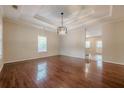 Spacious living room boasts hardwood floors, a modern light fixture, and recessed lighting at 134 N Alexander St, Buford, GA 30518
