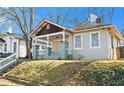 Cozy home featuring a covered front porch and mature trees in a peaceful neighborhood at 135 Adair Se Ave, Atlanta, GA 30315