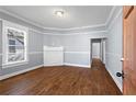 Bright living room with hardwood floors, fireplace, and large window for natural light at 135 Adair Se Ave, Atlanta, GA 30315