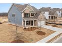 Attractive two-story home with blue siding, a two-car garage, and a well-kept front yard at 7181 Linden Dr, South Fulton, GA 30349