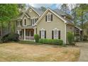 Charming two-story home with stone accents, shutters and manicured landscaping at 3997 Ironhill Ln, Woodstock, GA 30189