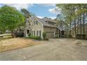 Attractive home featuring an attached garage and long driveway and lush, green lawn at 3997 Ironhill Ln, Woodstock, GA 30189
