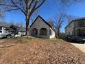 Charming brick home featuring arched porch and mature shade tree at 880 Westmont Sw Rd, Atlanta, GA 30311