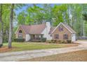 Charming two-story home with brick accents, a well-manicured lawn, and mature trees at 270 Albertas Ct, Mcdonough, GA 30252