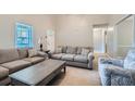Comfortable living room featuring plush couches, a coffee table, and a window with natural light at 270 Albertas Ct, Mcdonough, GA 30252