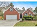 Well maintained single Gathering brick home with two-car garage and manicured lawn at 46 Centerport Dr, White, GA 30184
