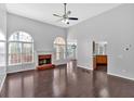 Bright living room featuring hardwood floors, vaulted ceiling, fireplace, and lots of natural light at 46 Centerport Dr, White, GA 30184
