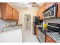 Well-lit kitchen features granite countertops and stainless steel appliances at 1250 Parkwood Cir # 2312, Atlanta, GA 30339
