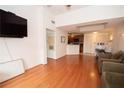 Open-concept living room with hardwood floors connected to a kitchen at 1250 Parkwood Cir # 2312, Atlanta, GA 30339