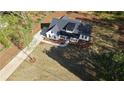 Stunning aerial view of a modern farmhouse with a well-manicured lawn and charming curb appeal at 1632 Oleander Sw Dr, Lilburn, GA 30047
