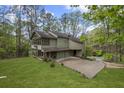 Stylish home with a modern design and a lush green lawn and beautiful wooded setting at 1670 Nordic Trce, Marietta, GA 30068