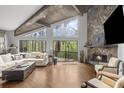 Spacious living room with a stone fireplace, wood beams, and large windows offering nature views at 1670 Nordic Trce, Marietta, GA 30068