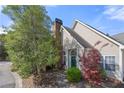 Charming home featuring a well-maintained lawn with mature trees and an inviting facade at 1478 Settlers Walk Sw Way, Marietta, GA 30060