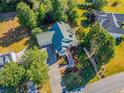 Aerial view of a well-maintained home with a spacious yard and a driveway leading to a garage at 250 Blackberry Ln, Douglasville, GA 30134