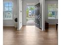 Bright foyer with wood floors and view of the home across the street at 133 Bastian Rd, Mcdonough, GA 30252