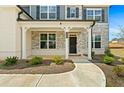 Inviting covered front porch with stone accents, offering a welcoming entrance to the home at 133 Bastian Rd, Mcdonough, GA 30252