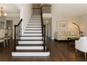 Welcoming foyer with staircase and hardwood floors, leading to living and dining areas at 2296 Valley Brook Ne Way, Atlanta, GA 30319