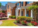 Stunning brick home showcasing a lush front yard with colorful flowers and a welcoming porch at 2296 Valley Brook Ne Way, Atlanta, GA 30319