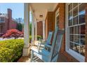 Inviting front porch with blue rocking chairs and views of the beautifully landscaped yard at 2296 Valley Brook Ne Way, Atlanta, GA 30319