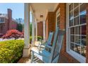Inviting porch with brick flooring and rocking chairs, offering a cozy outdoor seating area at 2296 Valley Brook Ne Way, Atlanta, GA 30319