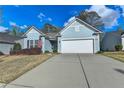 Charming, light blue single-story home featuring a two-car garage and well-maintained front yard at 4230 Braden Nw Ln, Kennesaw, GA 30144