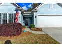 Inviting front entrance with a charming door, American flag, and beautiful landscaping at 4230 Braden Nw Ln, Kennesaw, GA 30144