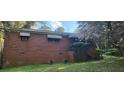A charming brick home exterior features a blossoming tree in its front yard at 102 Welch St, Stockbridge, GA 30281