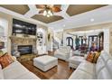 Inviting living room featuring a stone fireplace and built-in bookshelves at 2450 Weber Heights Way, Buford, GA 30519